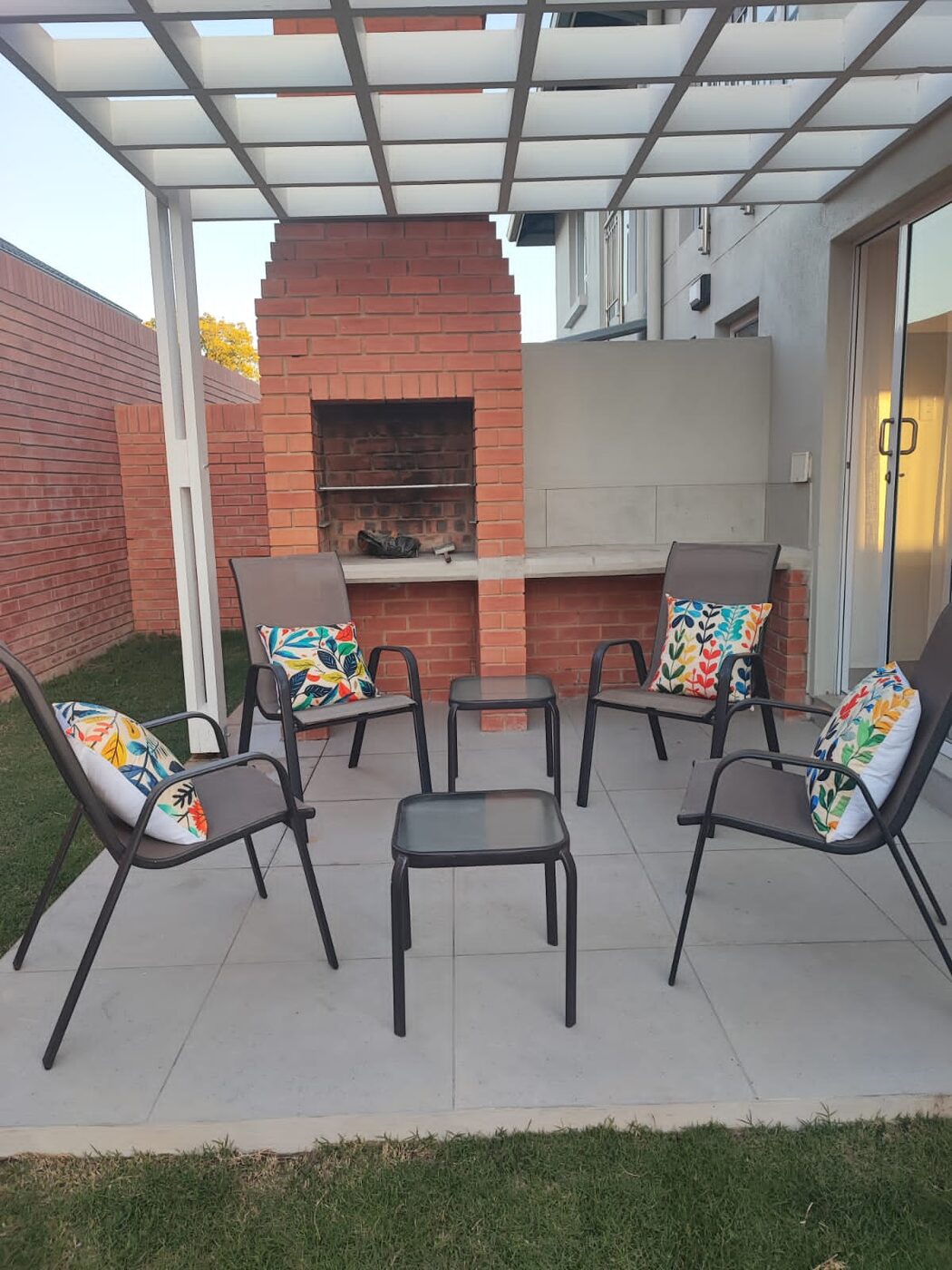 Clean undercover braai patio with seating at a Garden Route home